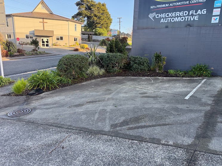 Tidied garden bed beside a commercial car park, Whangarei
