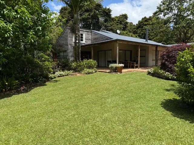 Striped, freshly mowed lawn in front of a country home in Whangarei